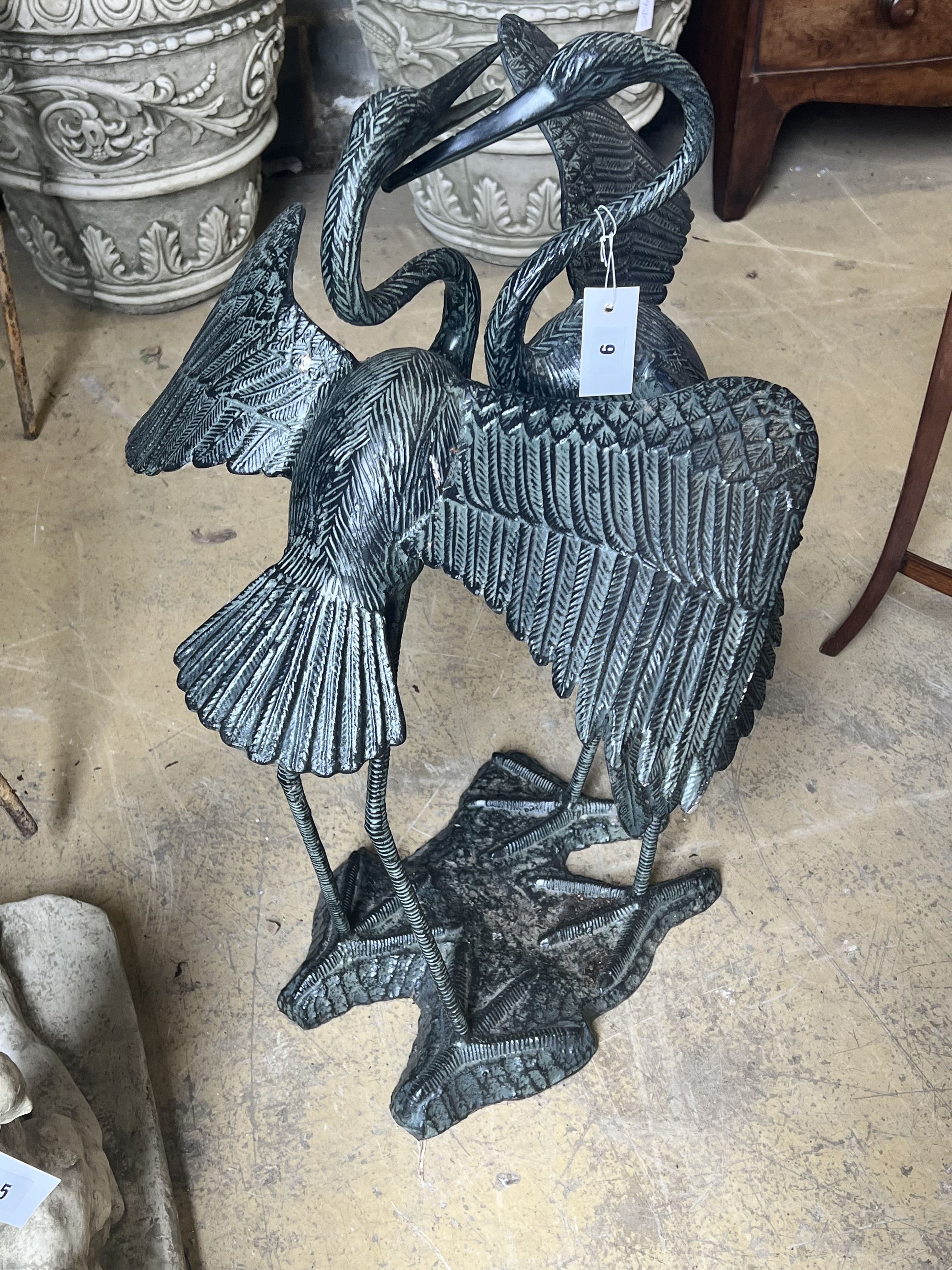 An aluminium bronze effect pair of dancing cranes, height 77cm
